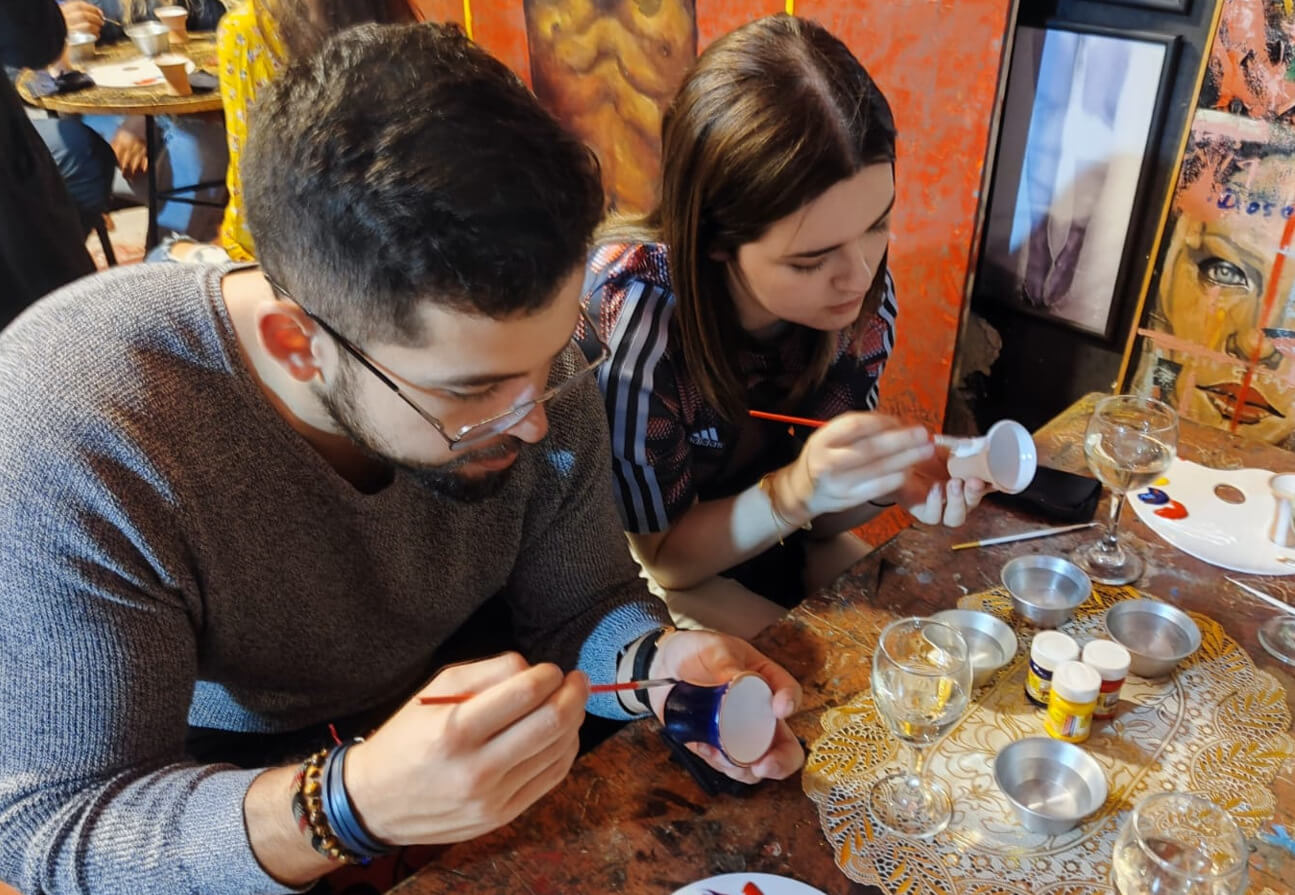 people painting shot glass in cusco tipsy tour